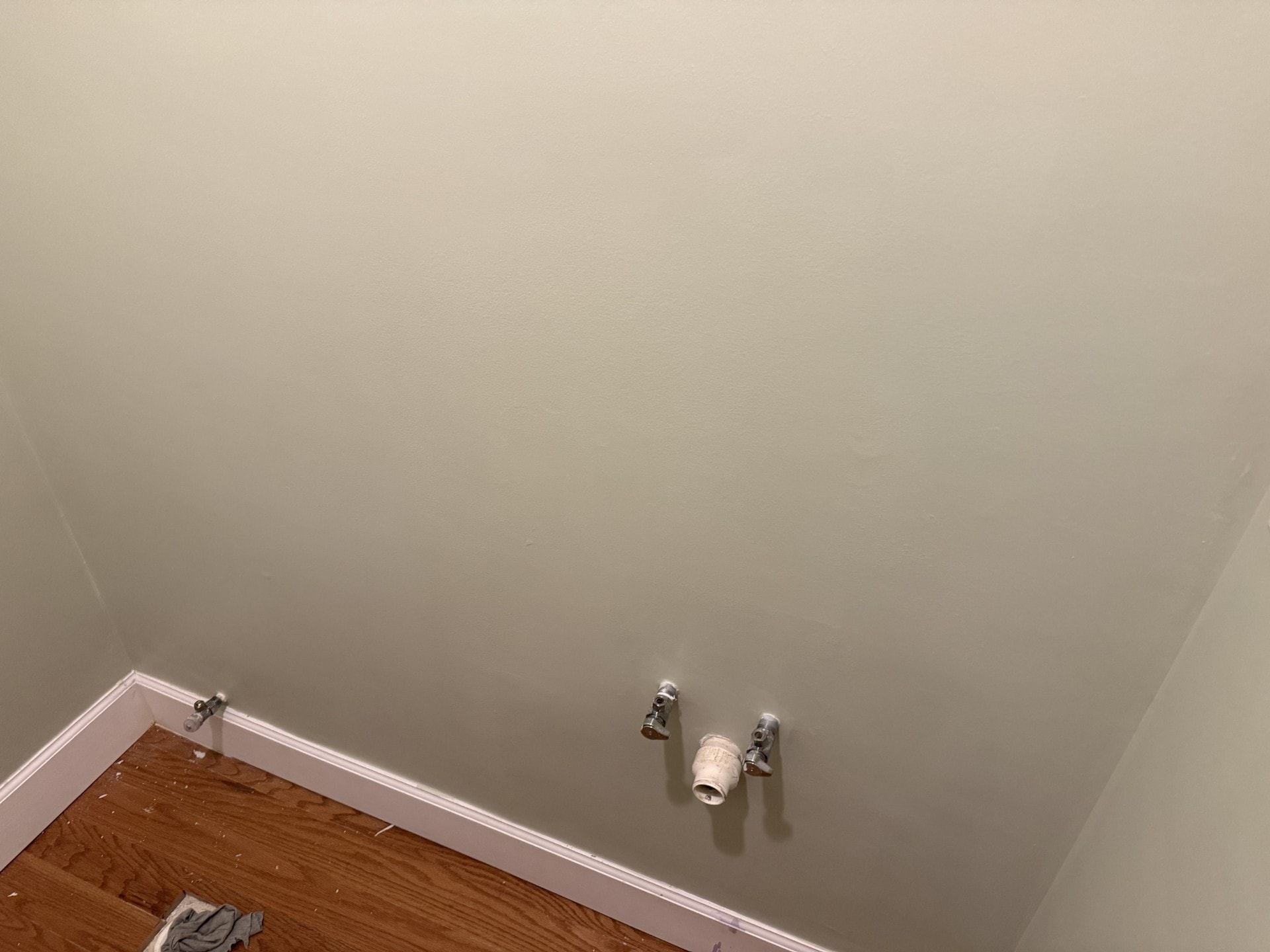 Finished bathroom walls with pedestal sink supply lines, smooth paint throughout