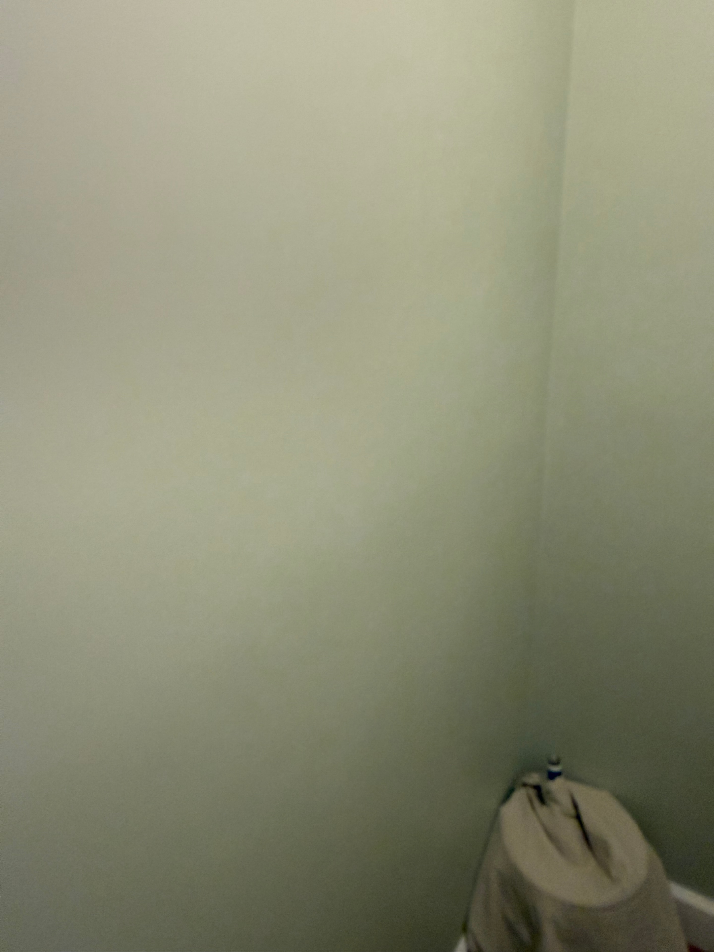 Smooth painted finish on the plumbing wall after patch and paint