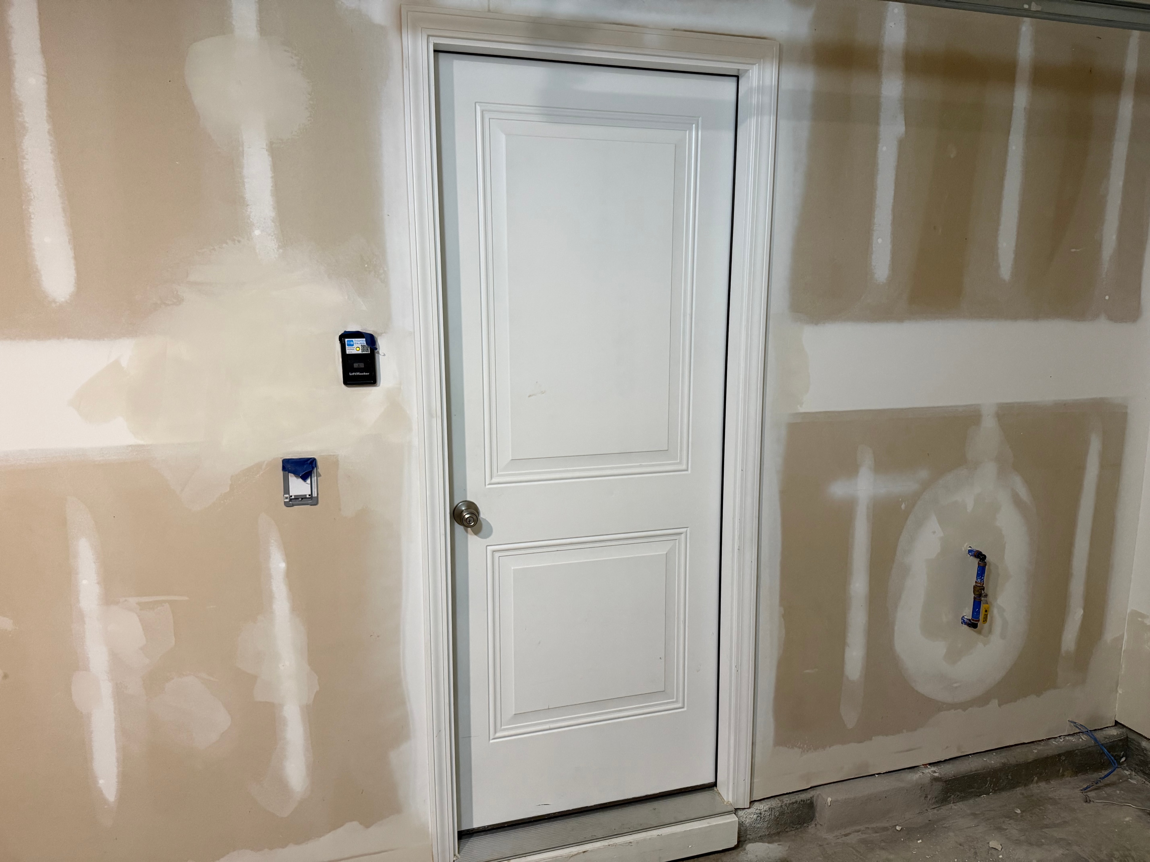Completed garage finish with smooth painted walls and ceiling