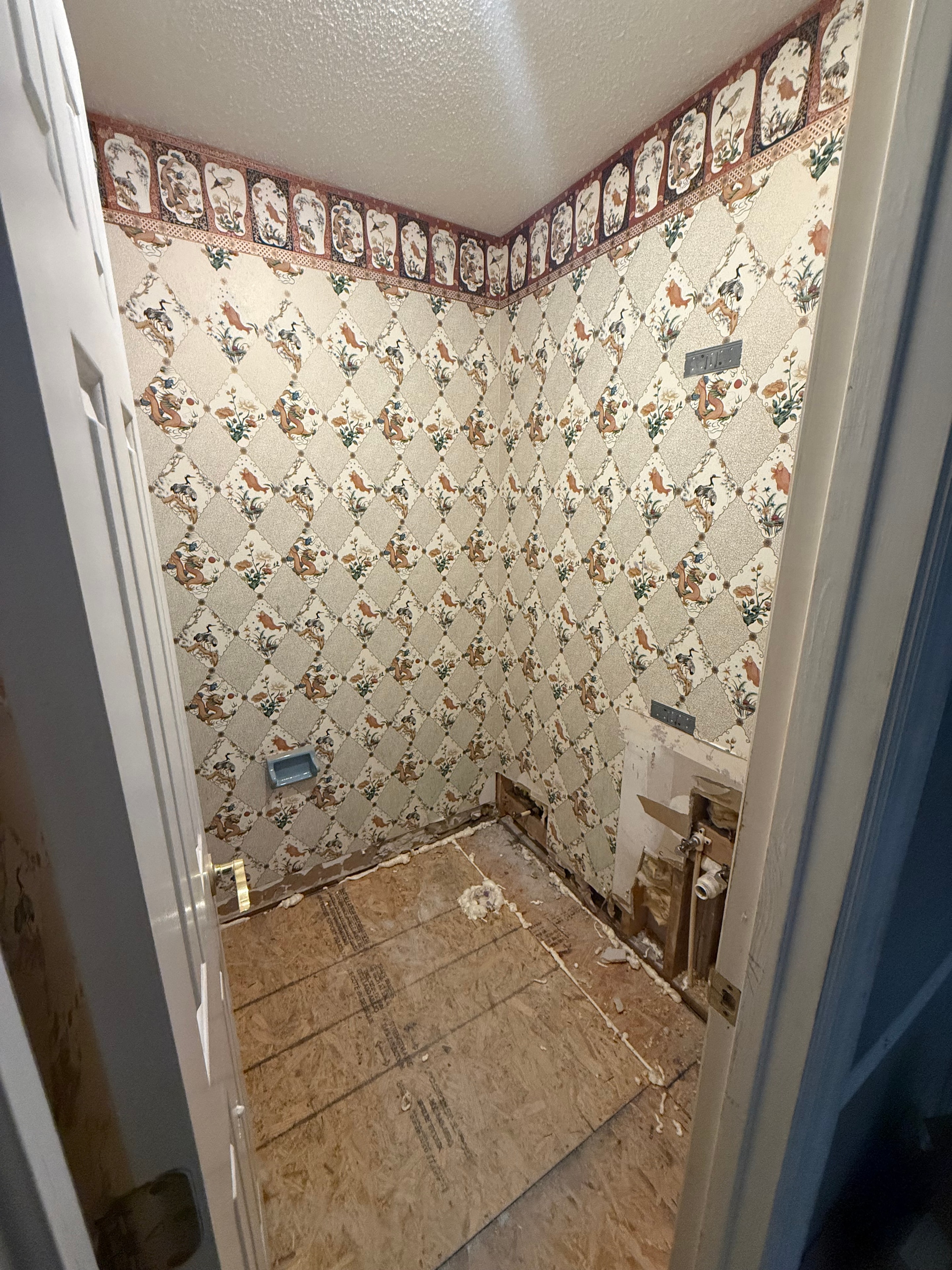 Bathroom with old wallpaper before removal