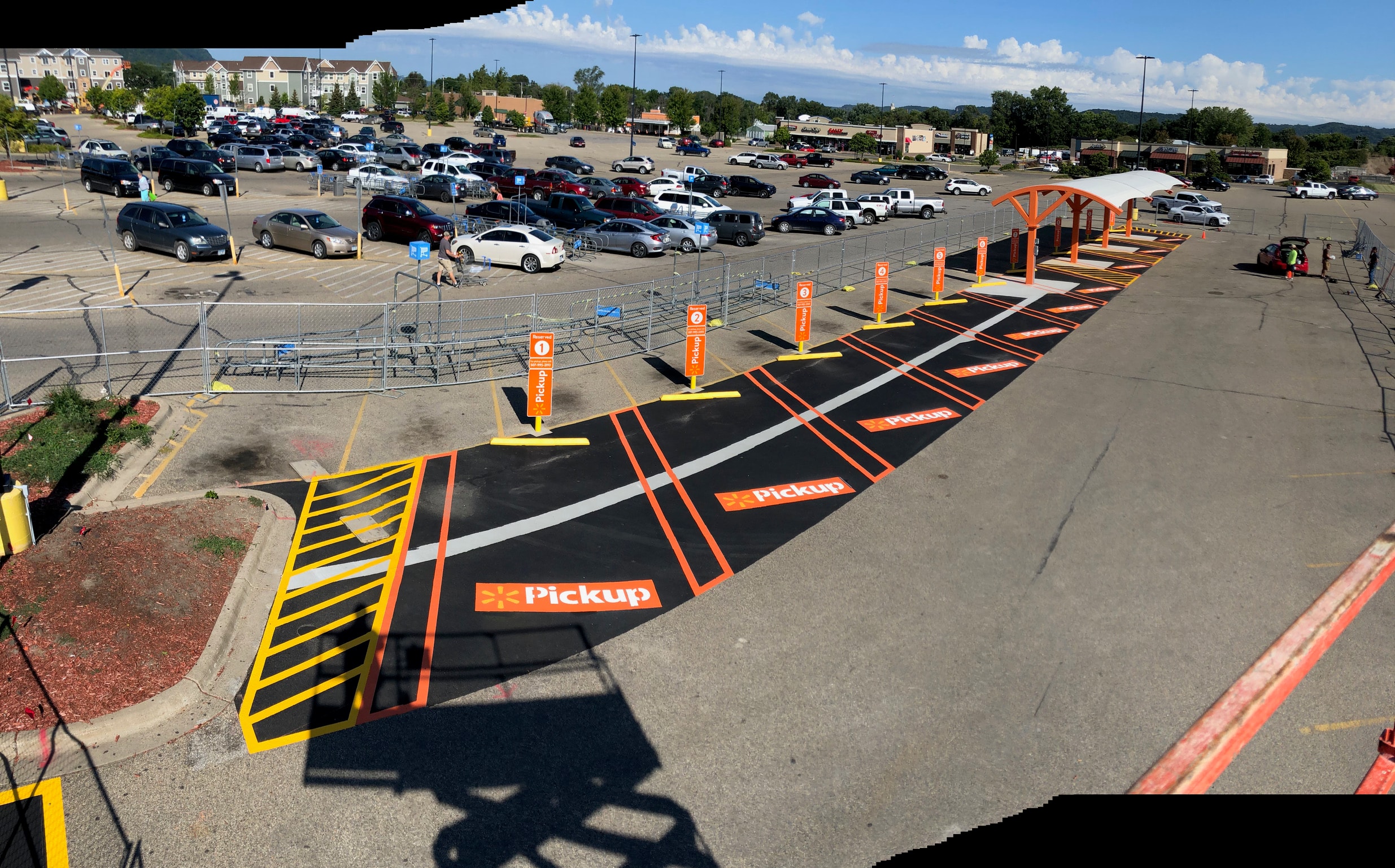 Walmart grocery pickup completed lot — fresh blacktop, orange striping, and Pickup logos — Winona, MN
