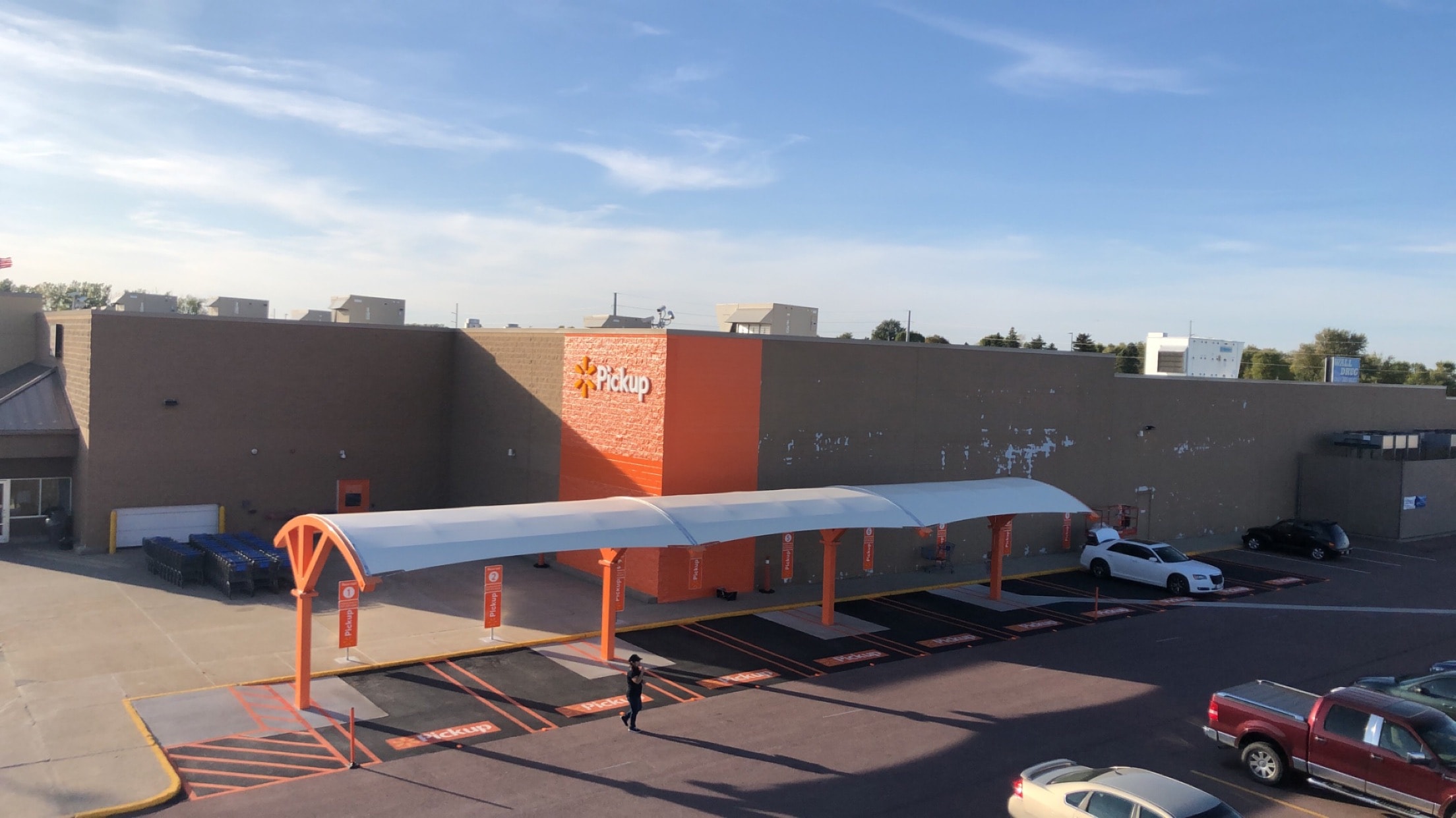 Walmart grocery pickup canopy, lot striping, and building corner paint — Worthington, MN